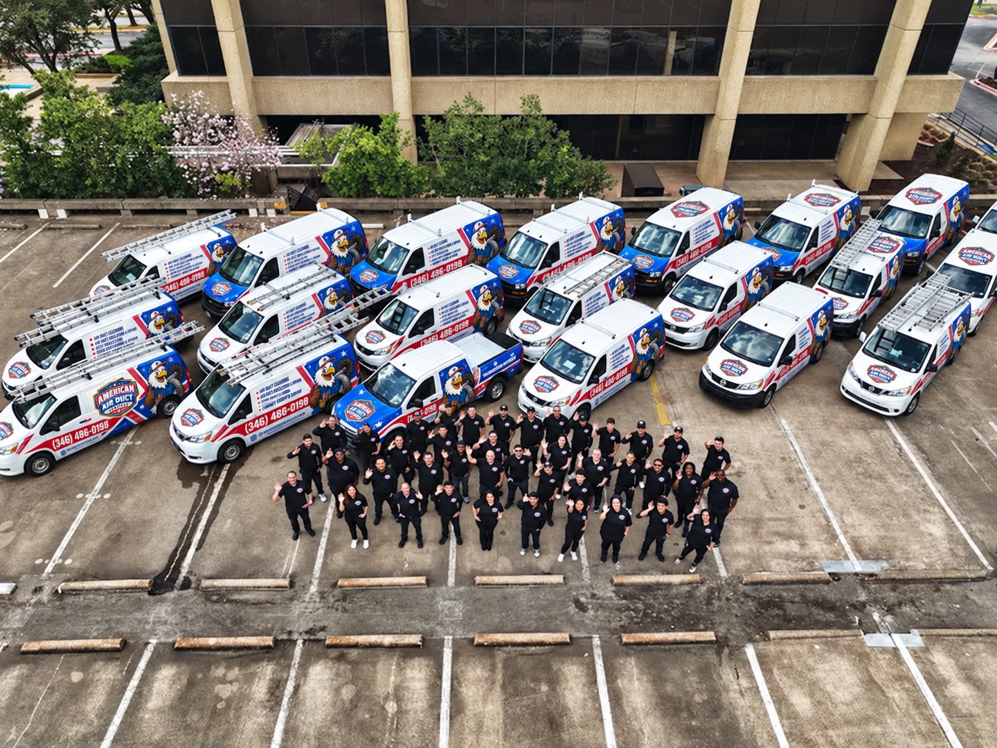 The American Air Duct Services team in front of their Houston fleet of branded vans